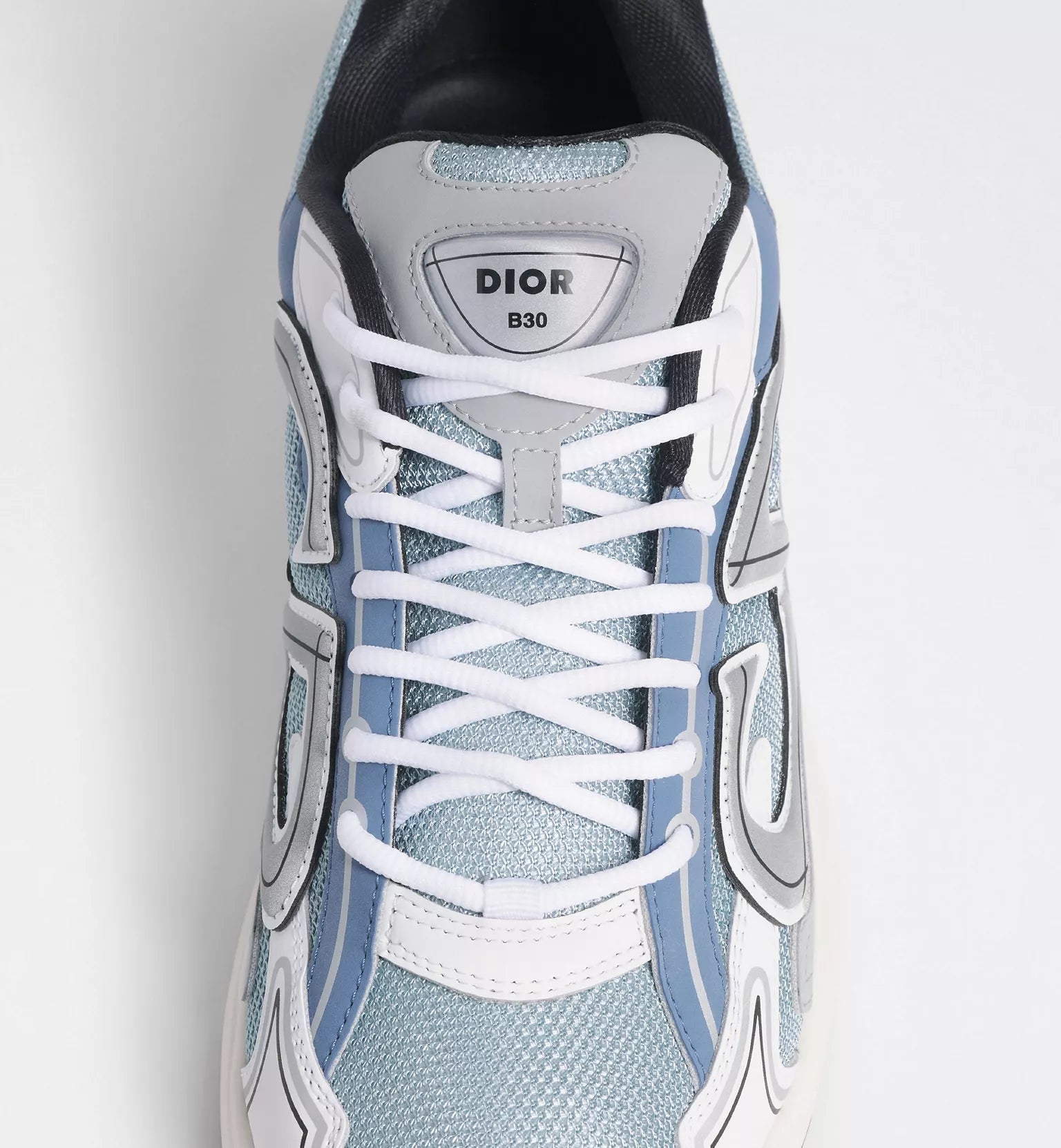 Dior B30 countdown sneaker tongue logo with white laces and light blue upper panels.