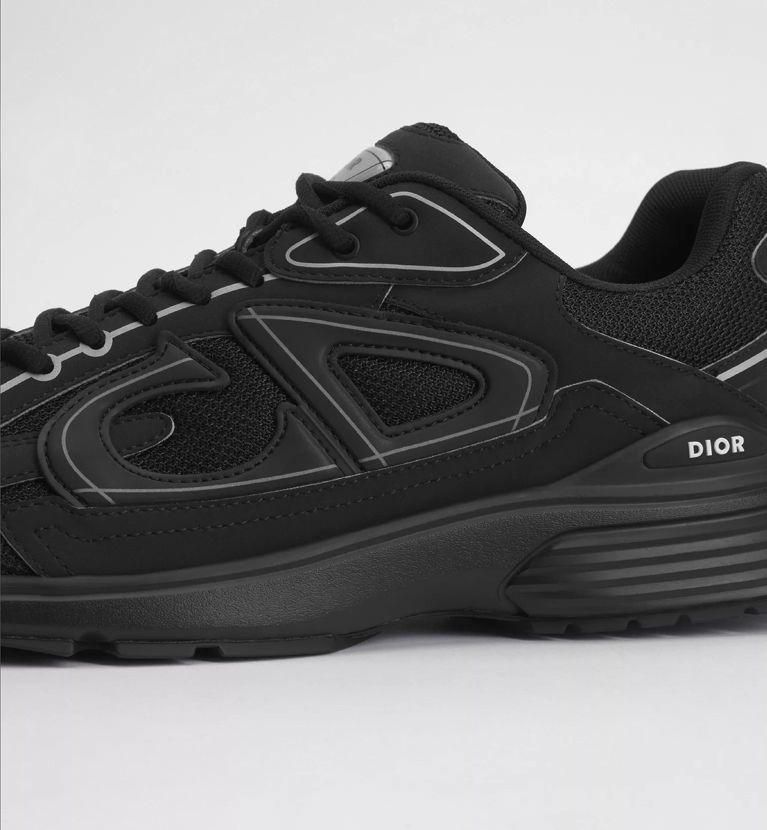 Black Dior B30 sneaker with textured panels, lace-up closure, and logo on side