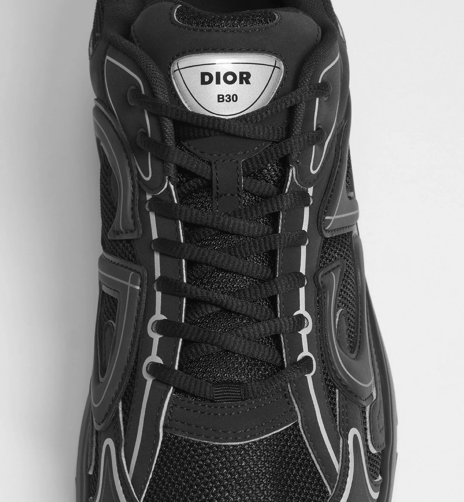 Black Dior B30 sneaker tongue patch with 'DIOR B30' label