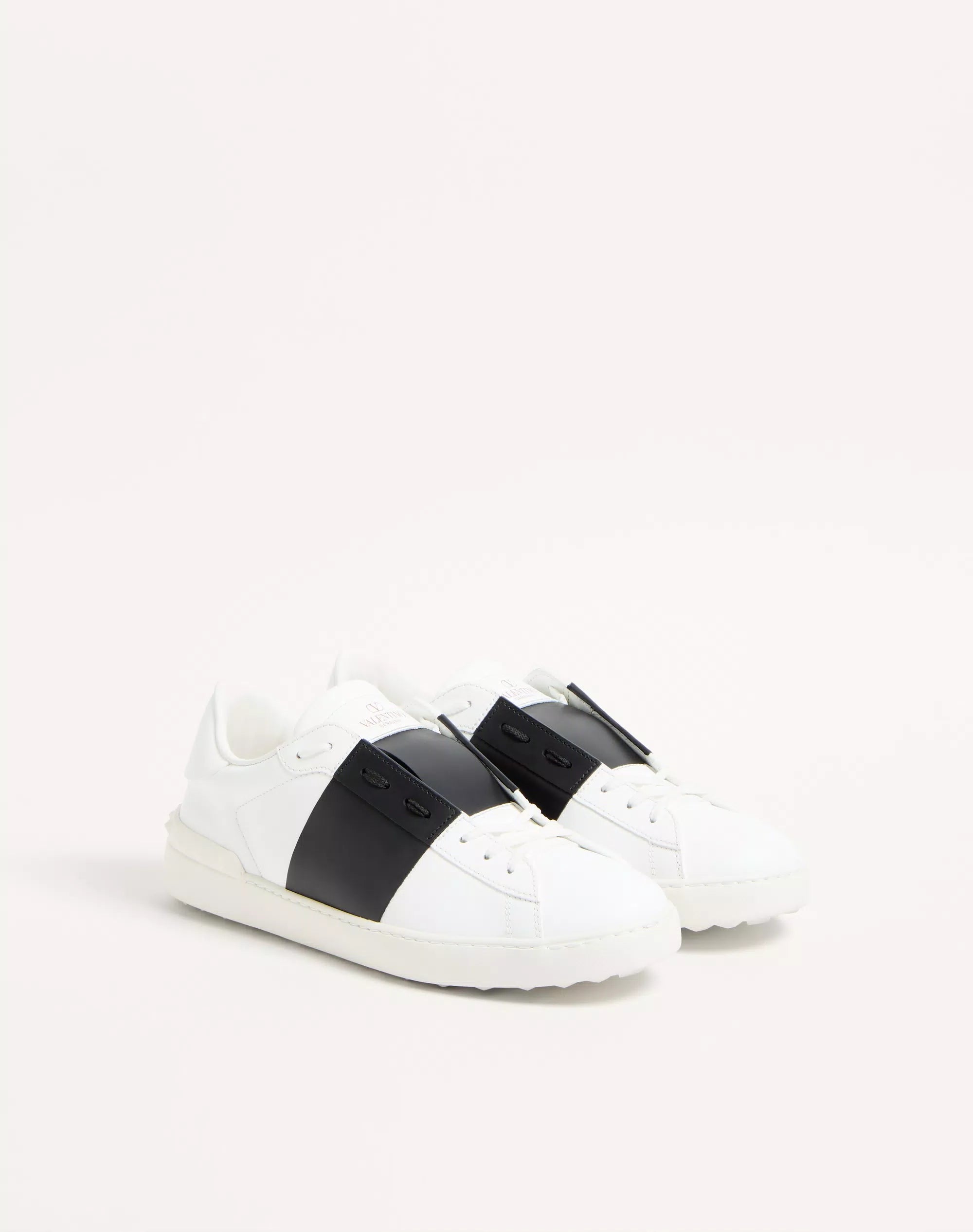 Calfskin open sneaker in white with black strap panels and lace-up front.