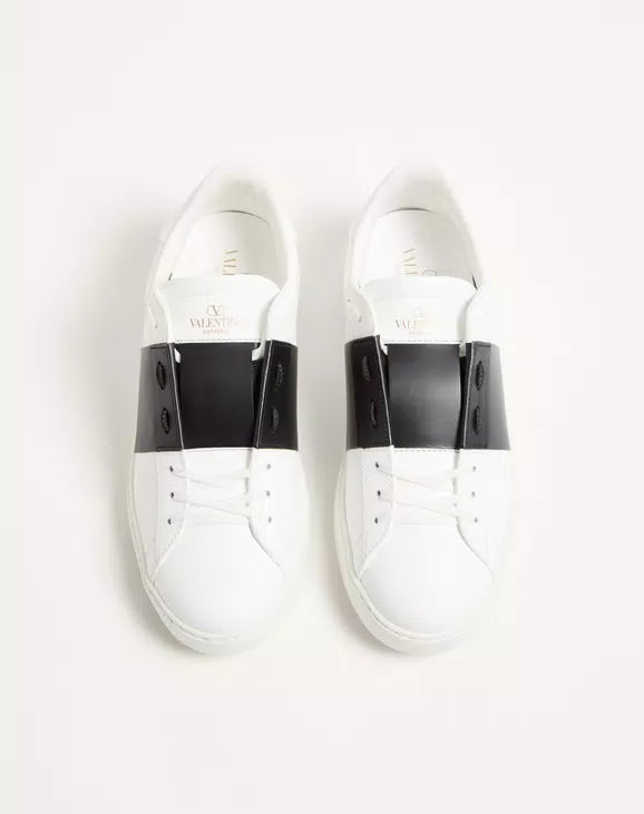 Calfskin open sneaker heel view in white with black heel tabs and lace-up.