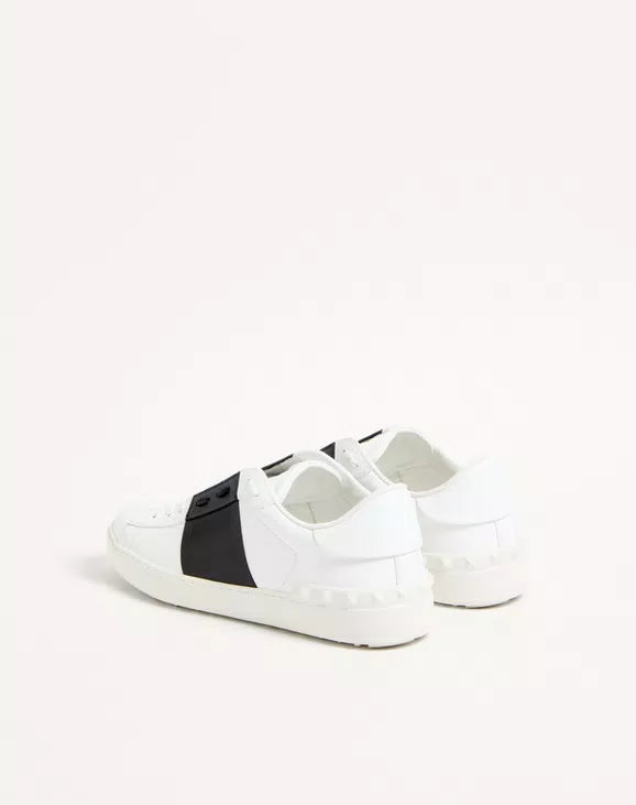Calfskin open sneaker, white with black side panel and strap detail, lace-up.