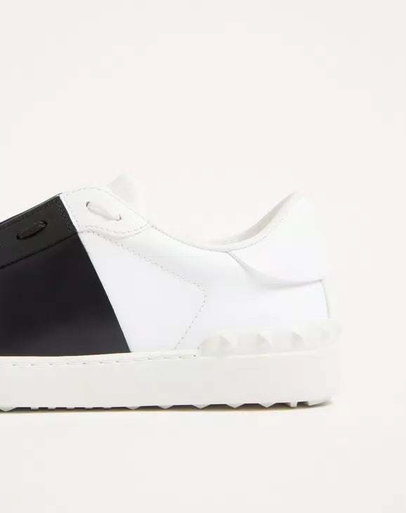 Calfskin open sneaker toe view: white leather with black strap panel and stitches.
