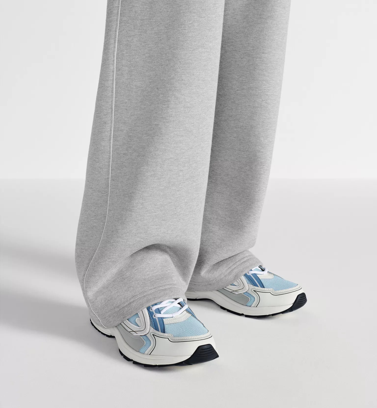 Dior B30 countdown sneakers worn with light gray pants; light blue and white design.