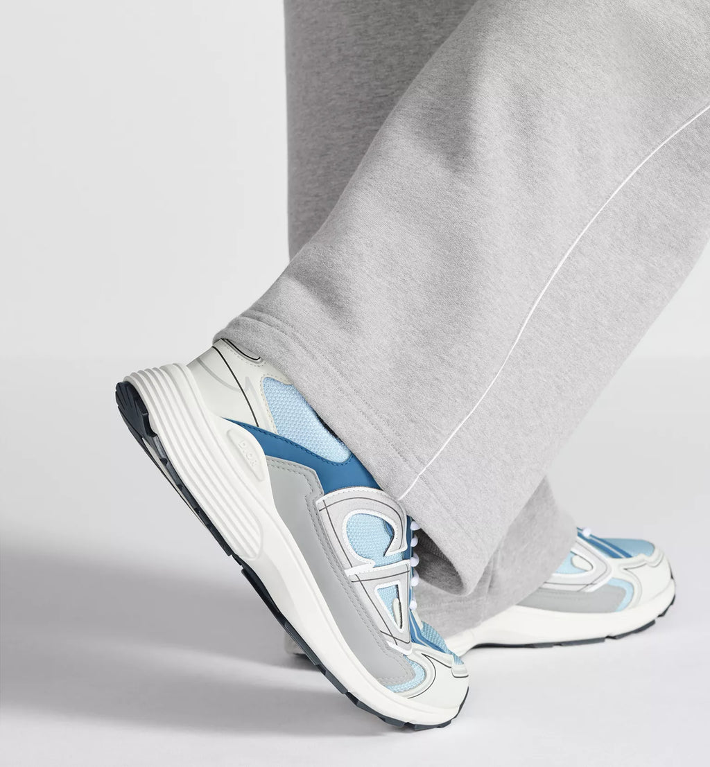 Side close-up of Dior B30 countdown sneaker with light blue mesh and white lace trim.