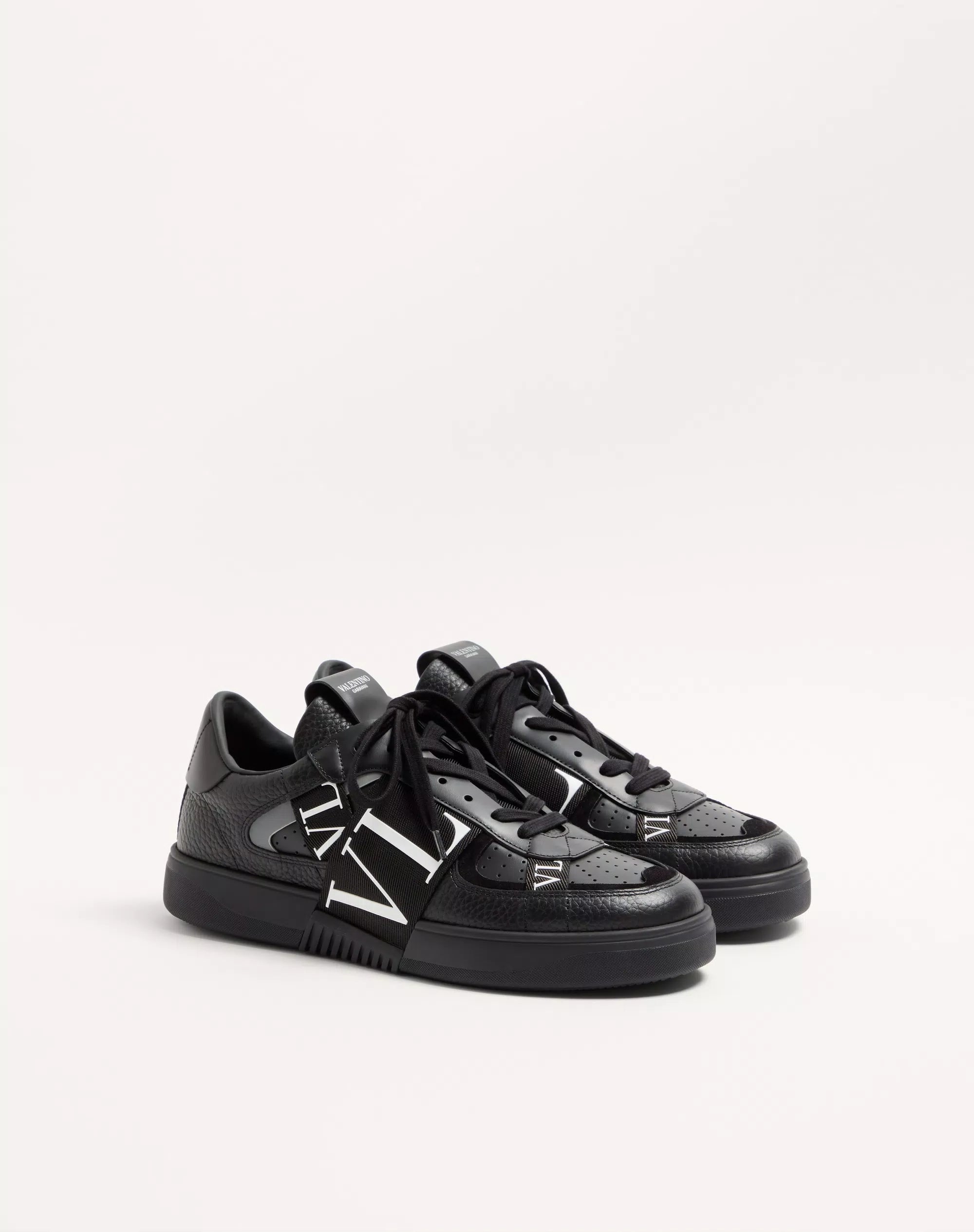 Black low-top leather sneaker with lace-up front and VL7N logo band on side