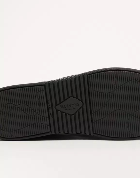 Black rubber outsole for low-top sneaker with textured tread and Valentino mark