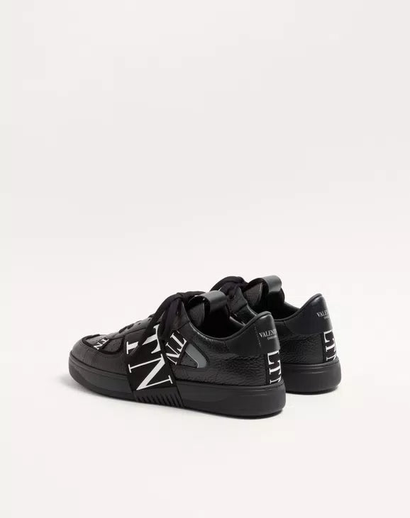 Black low-top leather sneaker heel view with lace-up closure and VL7N logo detail