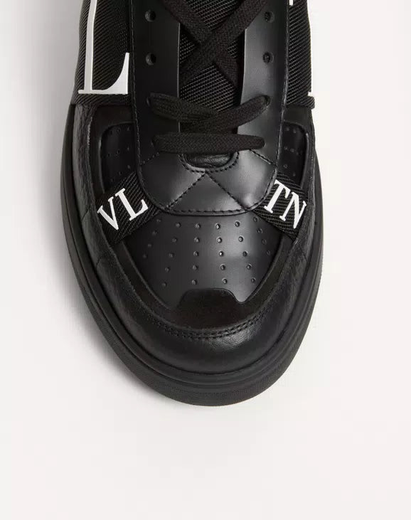 Black leather sneaker upper close-up with laces and VL7N bands on side