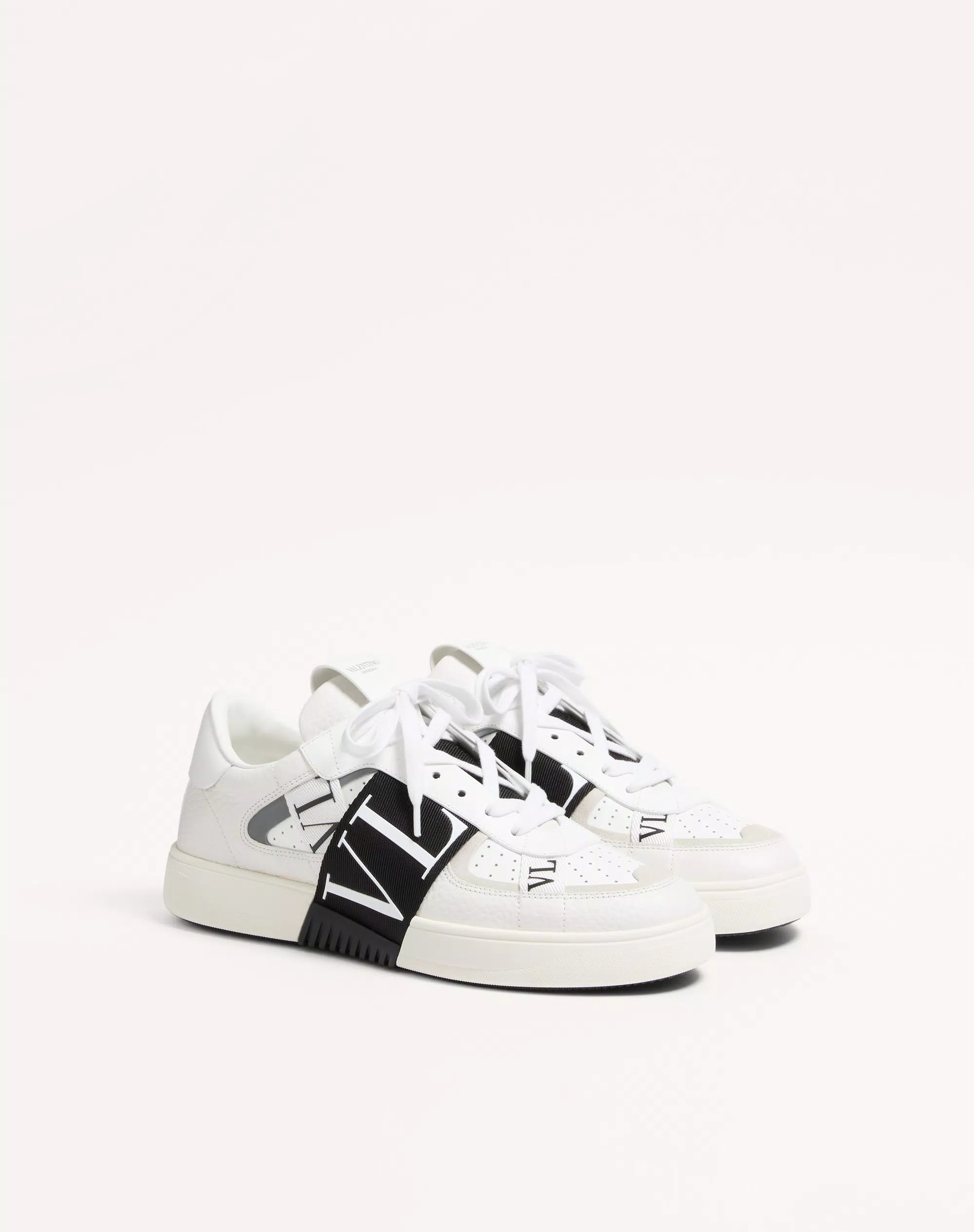 White low-top calfskin sneaker with black logo band and white laces
