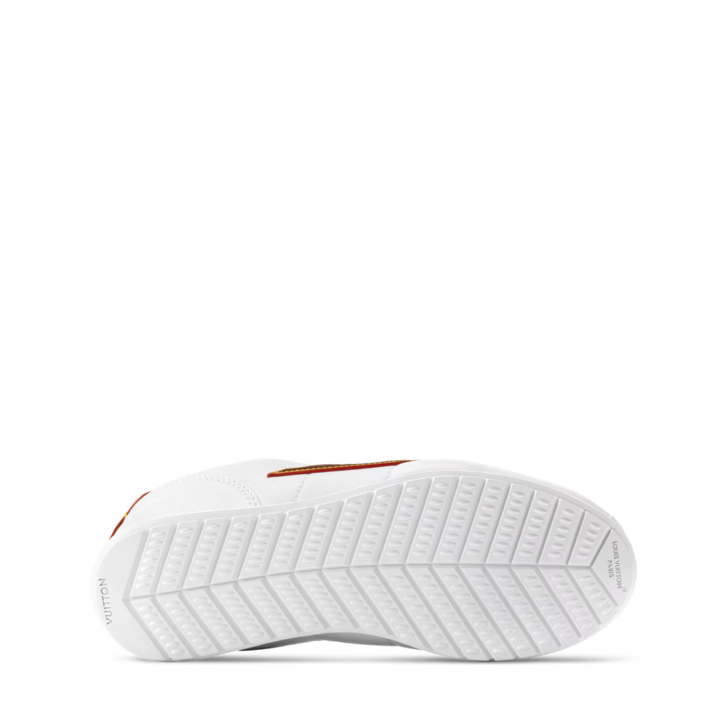 White LV Buttersoft sneaker outsole with grippy tread and orange trim on the side