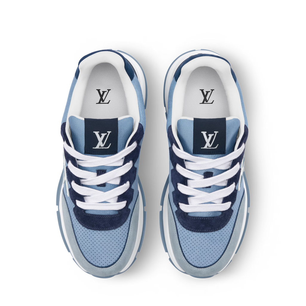 Pair of light blue sneakers with white laces, navy panels, and LV logos