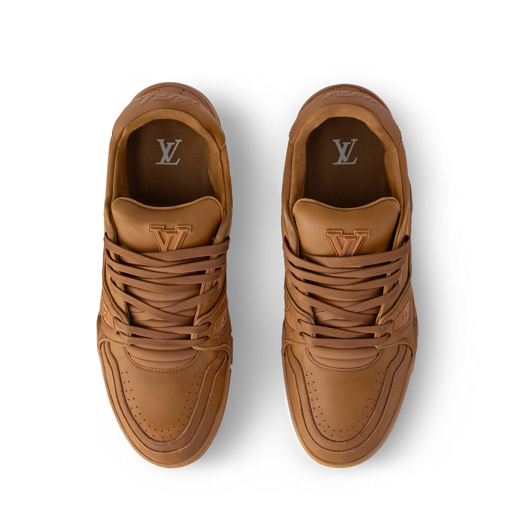 LV Trainer sneaker pair, tan with lace-up front and LV monogram on tongue and heel