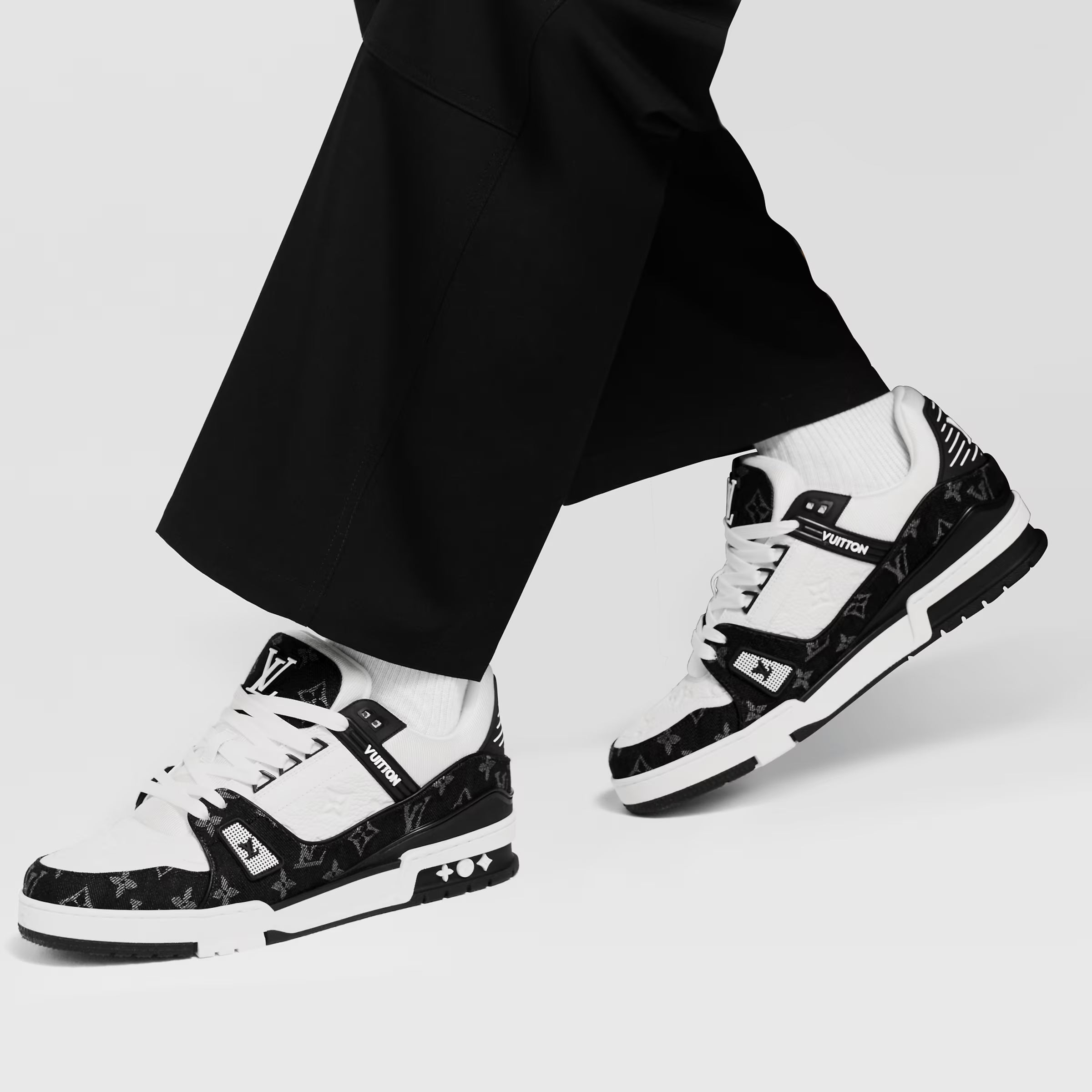 LV trainers worn with black pants and white socks, black-and-white sneaker profile