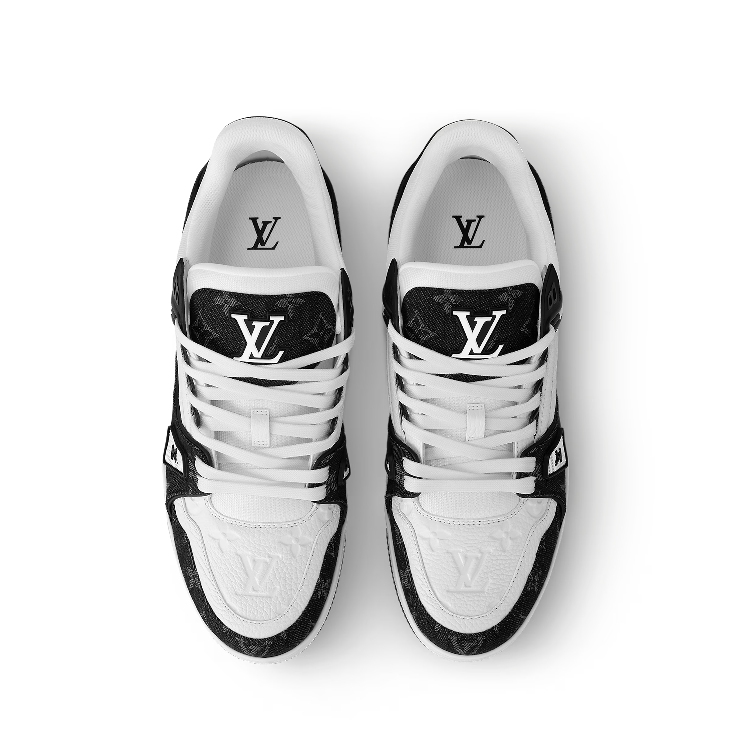 Pair of white and black LV trainers, top view with LV emblem on tongue and sides