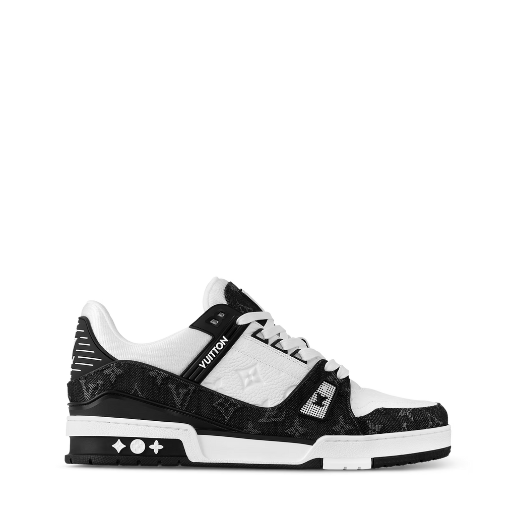 Side view of black and white LV trainers with signature LV detailing on upper
