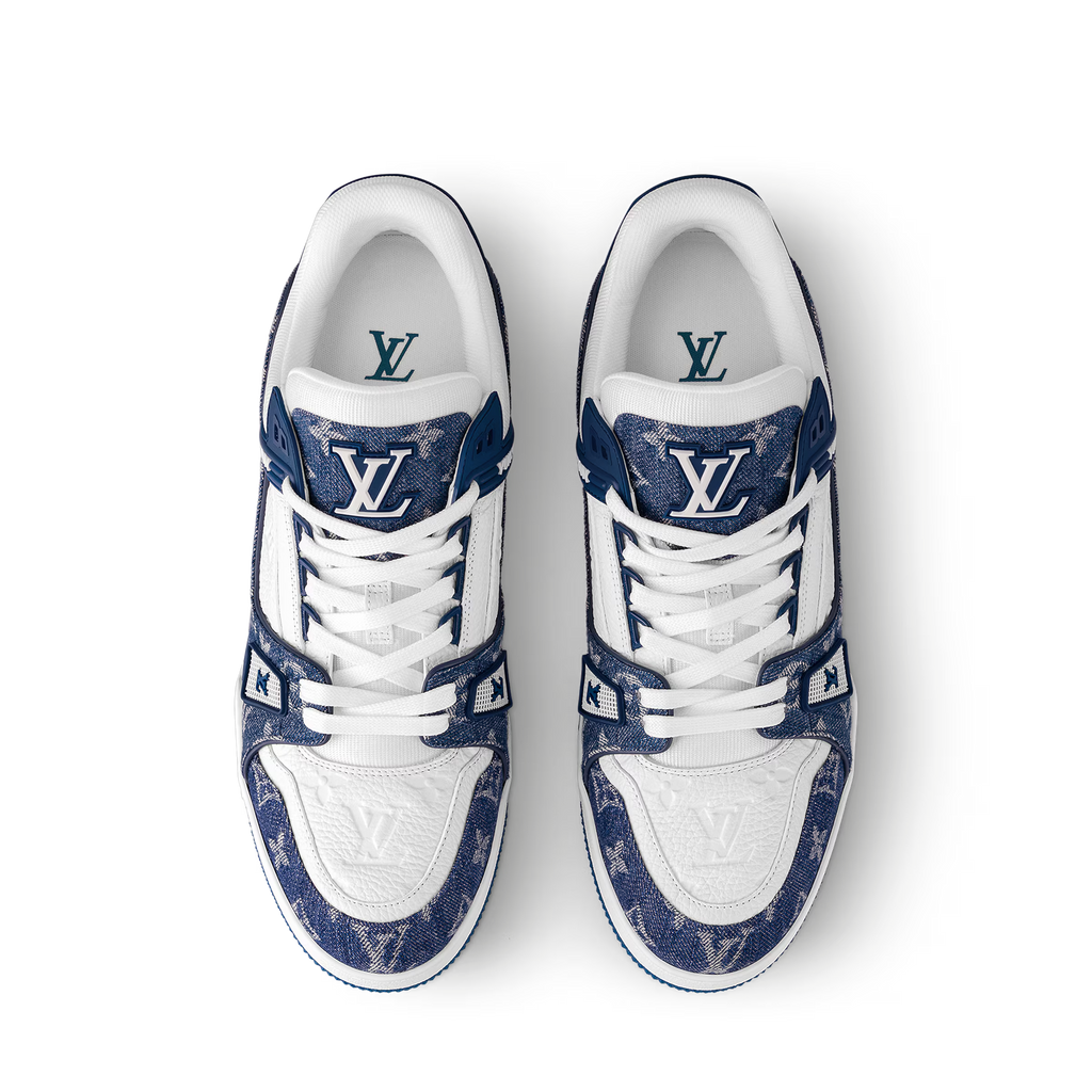 LV trainers, pair front view: white uppers, navy monogram overlays, and blue heel.