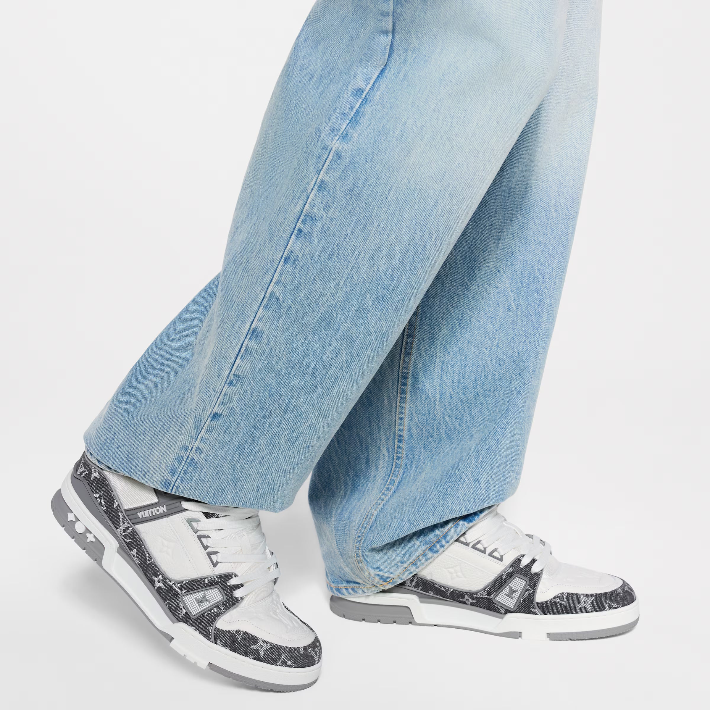 LV trainers with light blue jeans, dark monogram uppers, white rubber sole