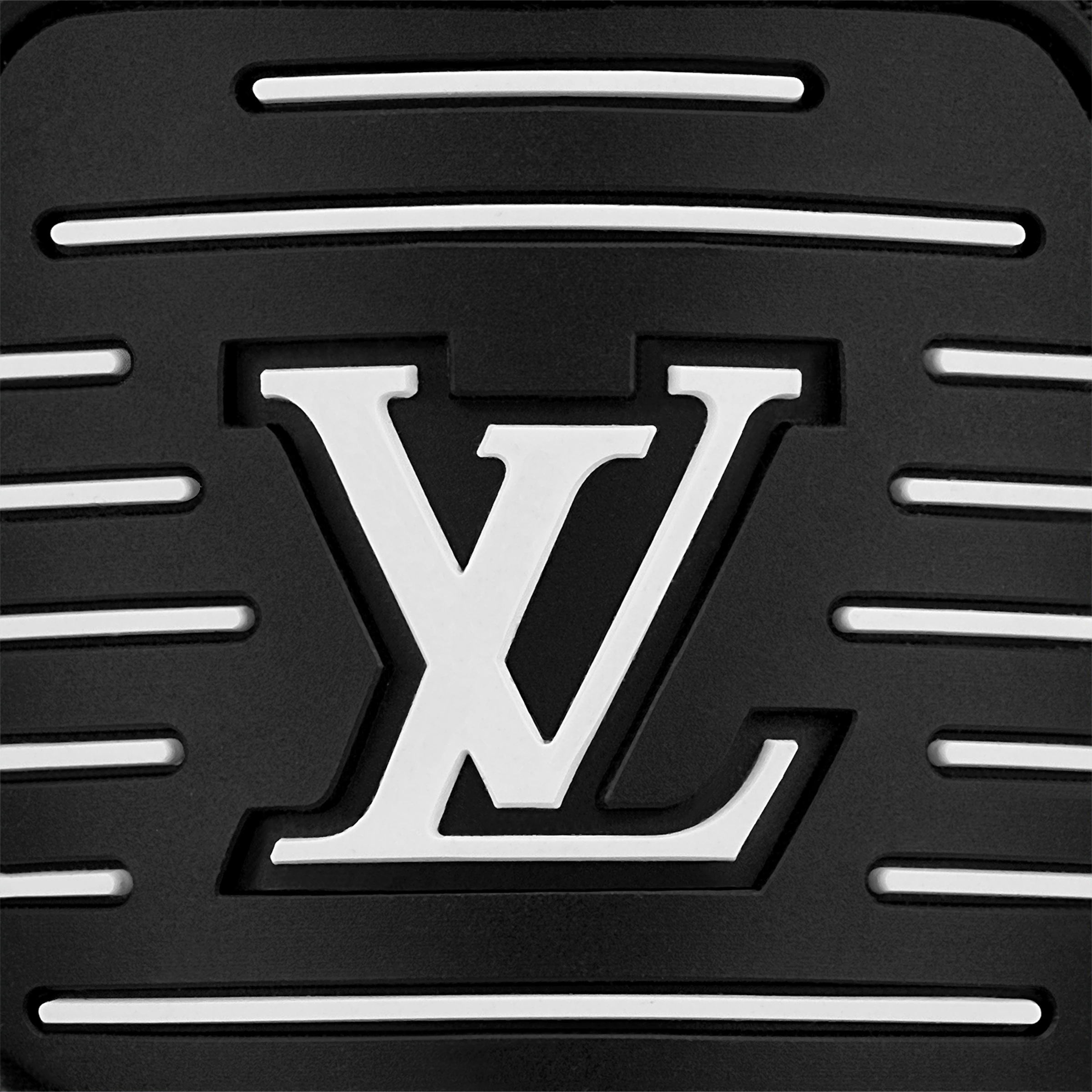 Close-up of embossed LV logo on black rubber sole tread