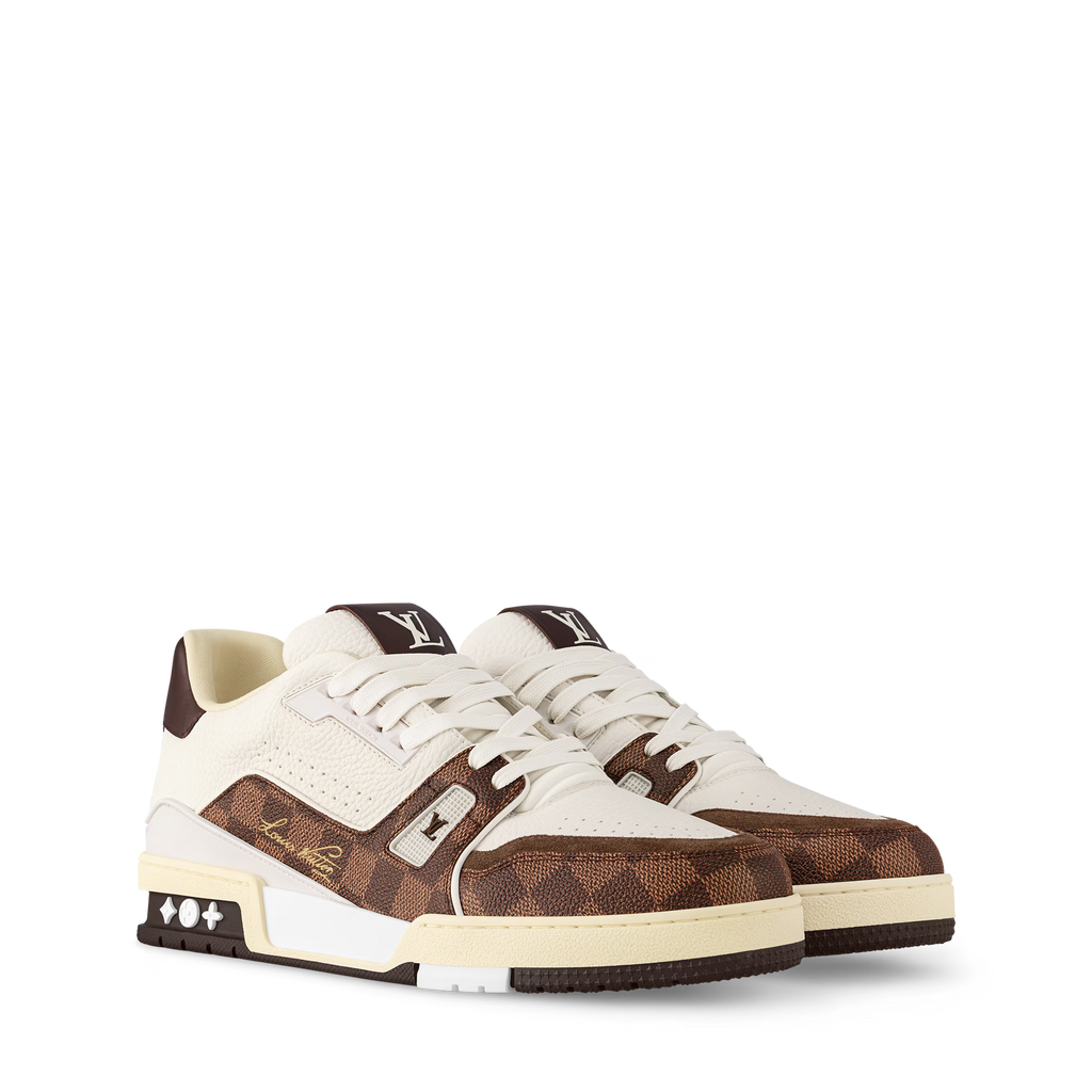 White and brown low-top sneakers with patterned panels, white laces, logo detail.