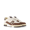 White and brown low-top sneakers with patterned panels, white laces, logo detail.