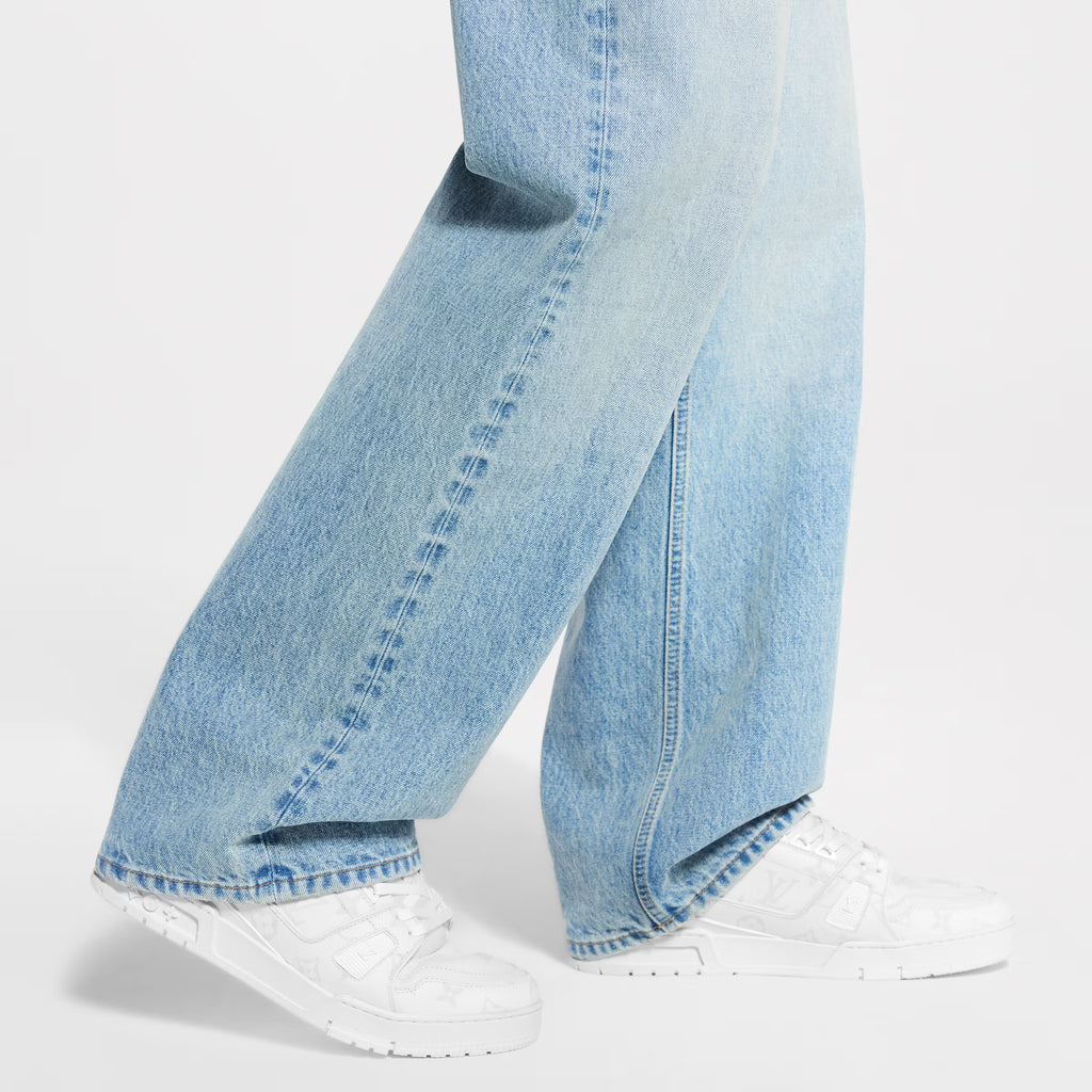 White LV Trainer sneaker worn with light-wash jeans
