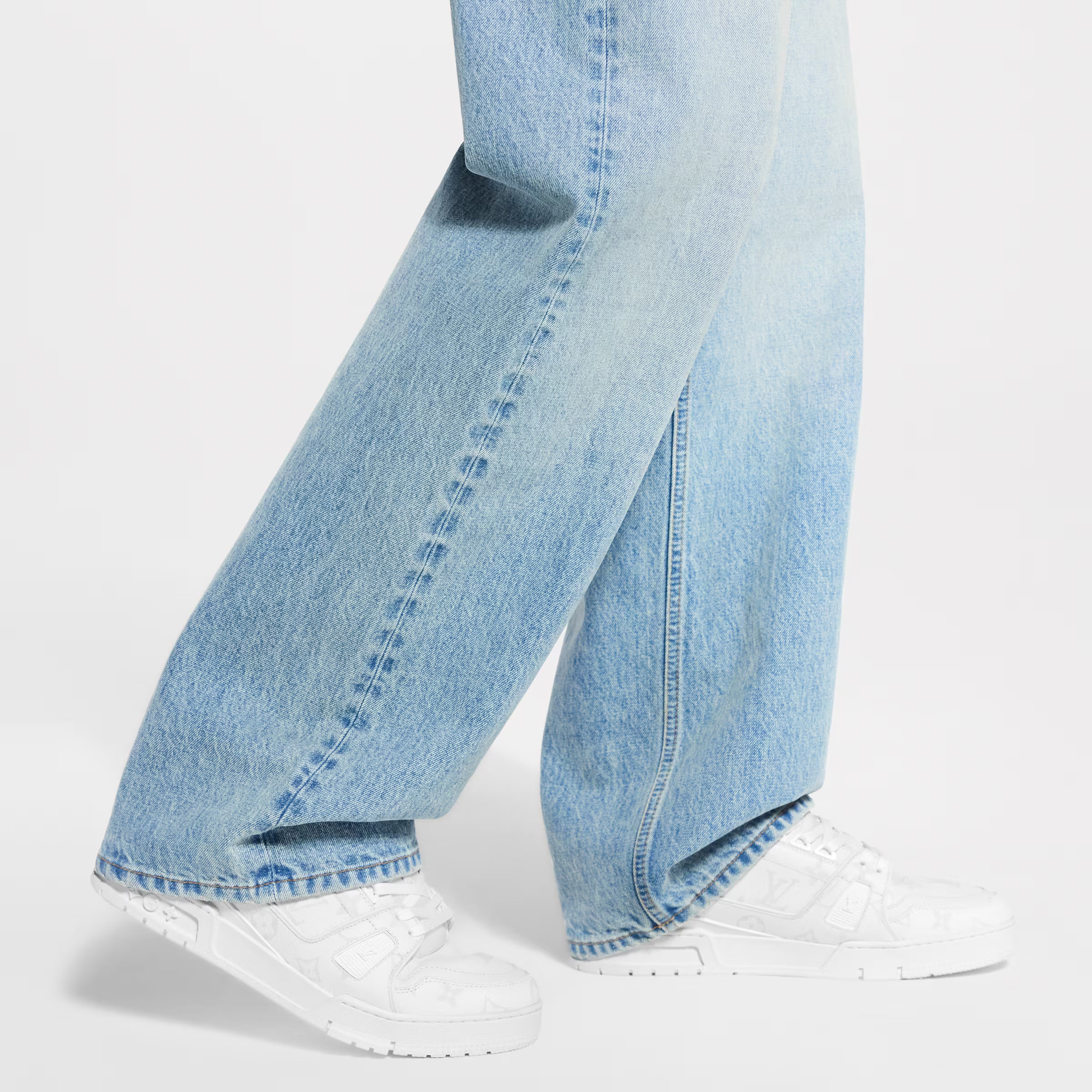 White LV Trainer sneaker worn with light-wash jeans
