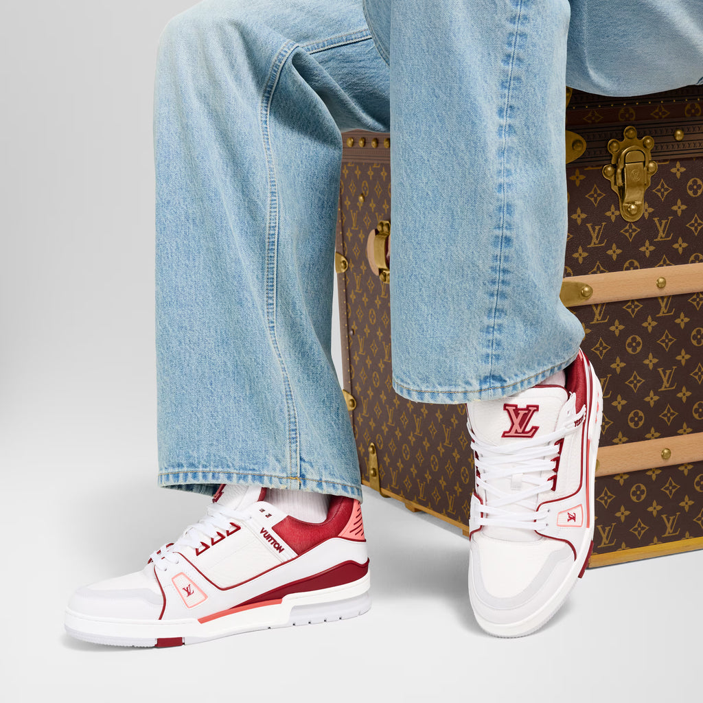 White and red LV low-top sneakers worn with light-wash jeans