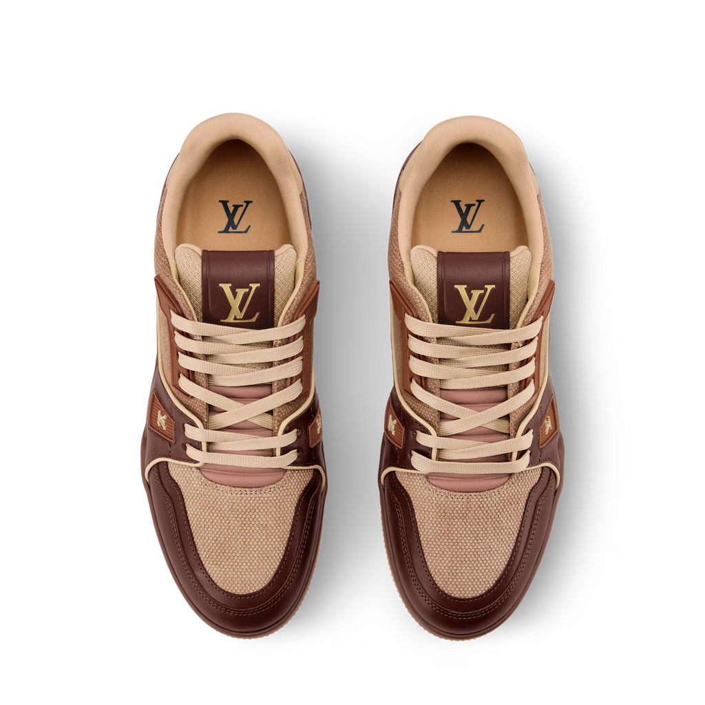 Pair of LV Trainer sneakers with dark brown uppers, tan laces, and LV branding on tongues