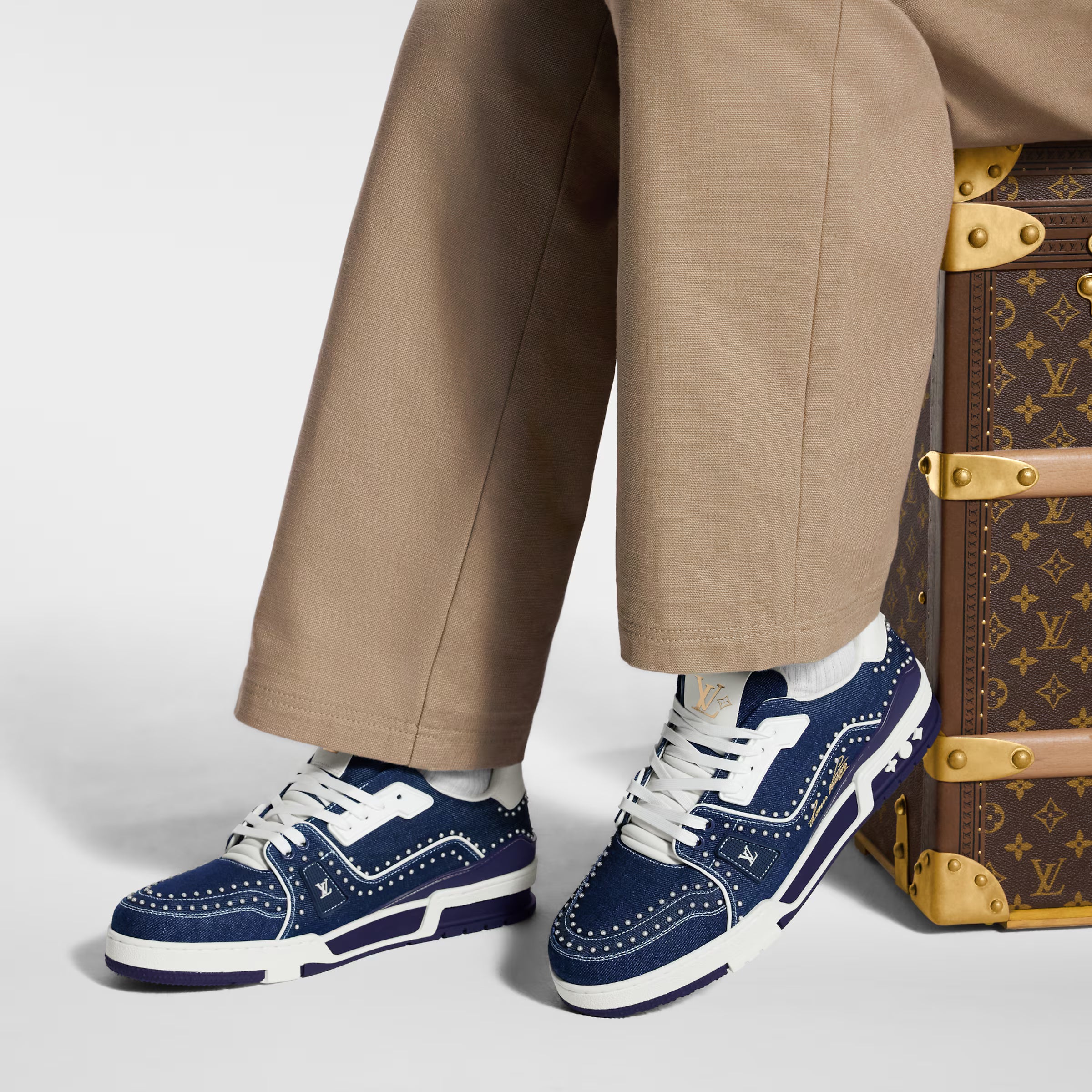 LV Trainer sneaker on foot, navy blue lace-up with white midsole and trim