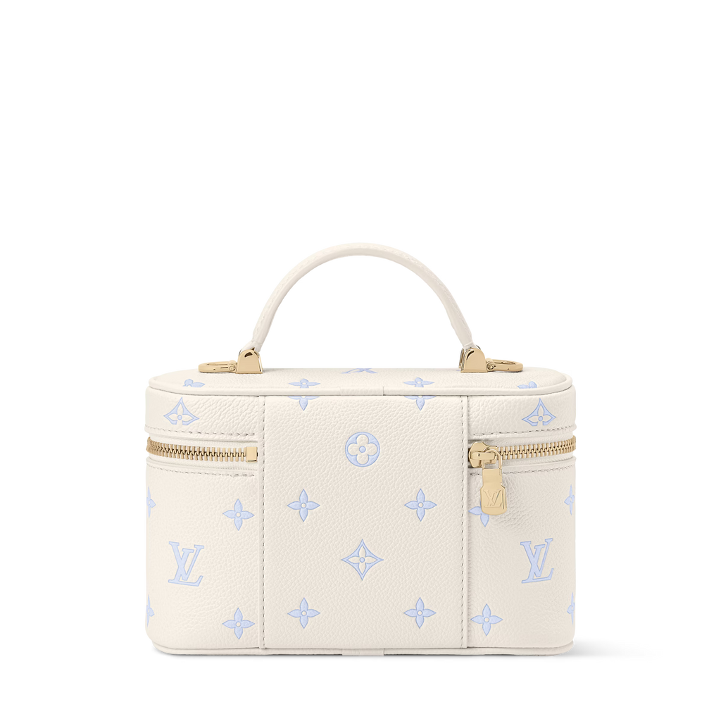 Cream vanity pouch with blue motifs, gold zipper, centered front logo, top handle