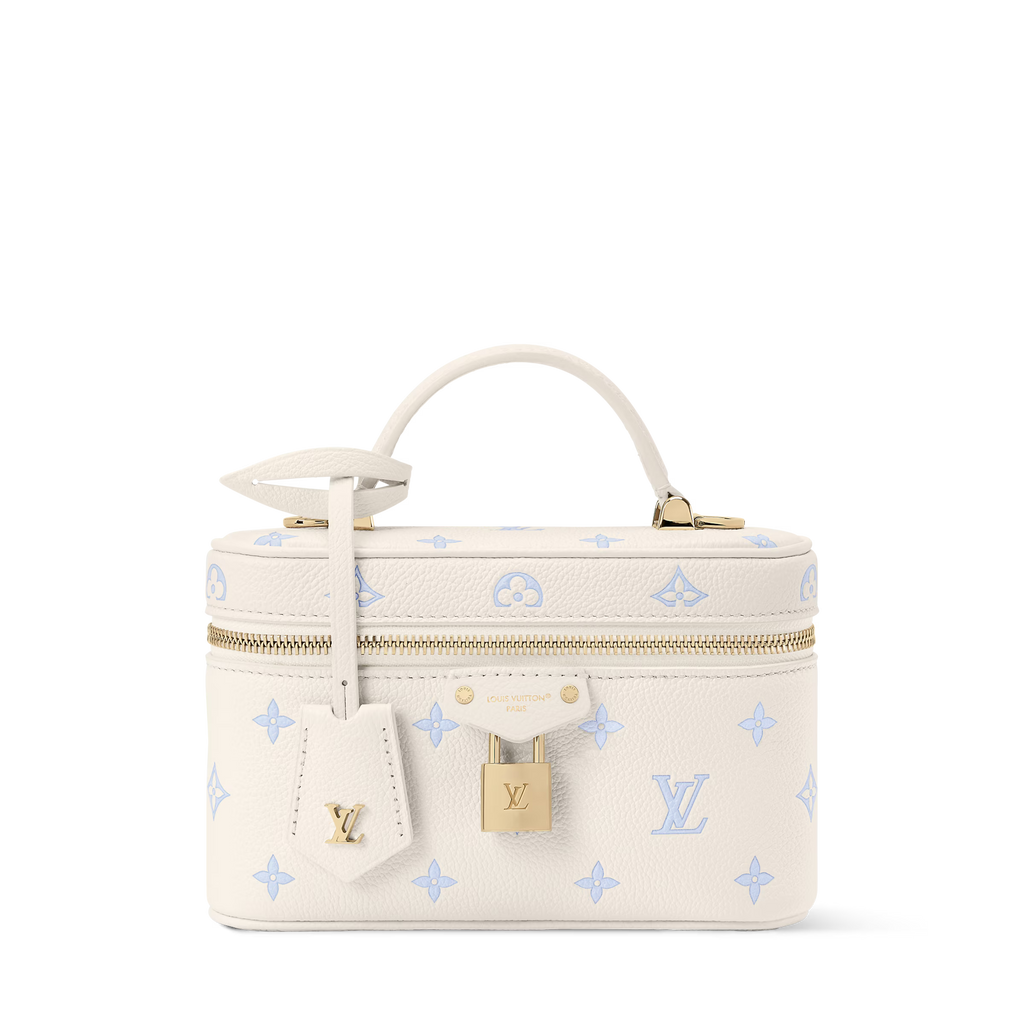 Cream vanity pouch with blue motifs, gold zipper, top handle, detachable chain strap